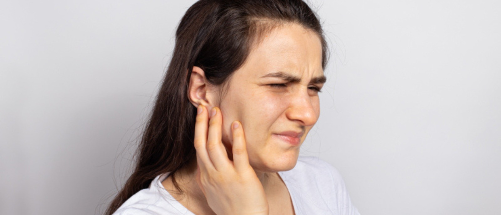 Middle-aged person surprised by hearing issues, breaking the myth of age and hearing loss